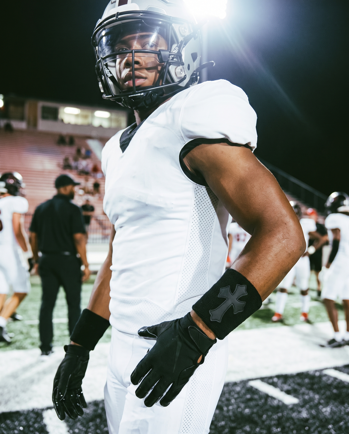 Player wearing the Black &amp; Black Cross Wristband under stadium lights