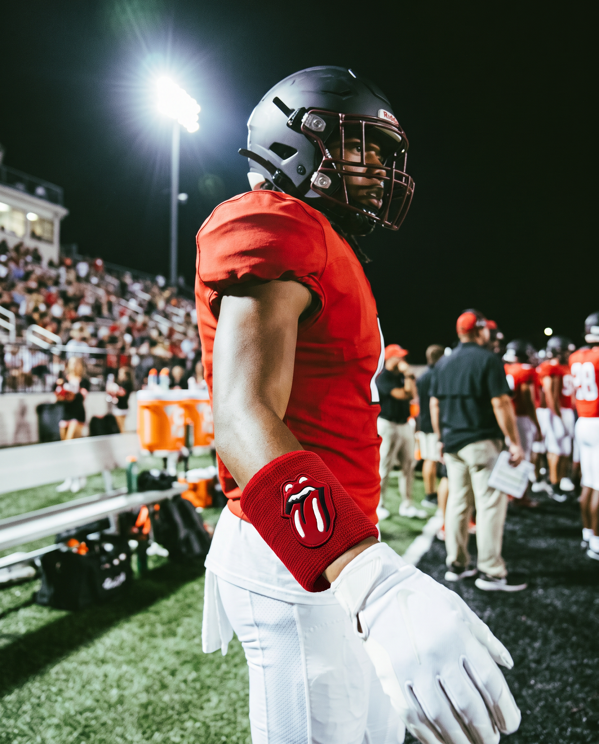 Player wearing the Red on Red RS Wristband under stadium lights