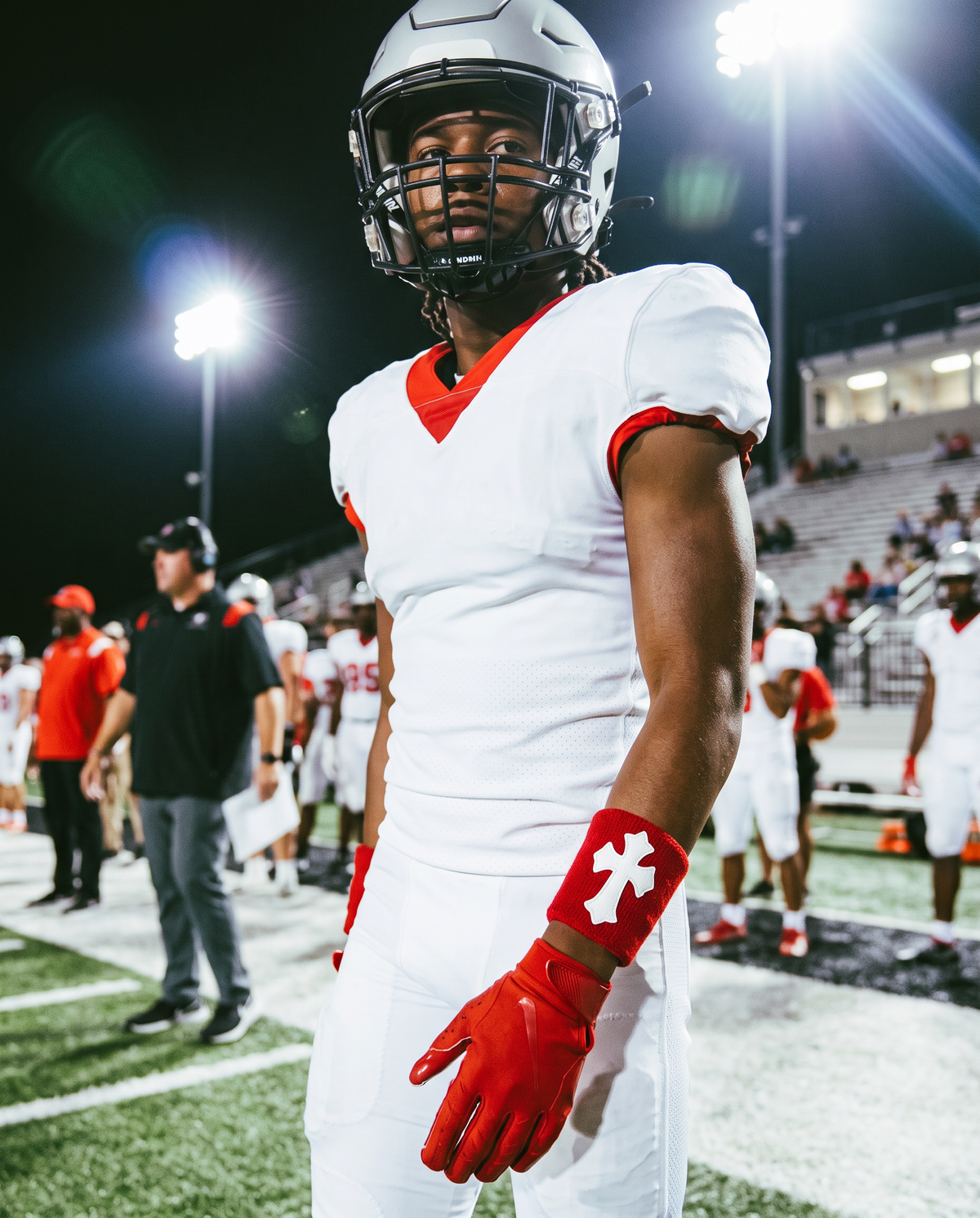 Player wearing the Red &amp; White Cross Wristband under stadium lights